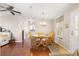 Warm and inviting dining area with wood flooring and view of kitchen and living area at 1854 W Schwartz Blvd, Lady Lake, FL 32159