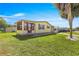 Beautiful single-story home, well-manicured lawn, and a delightful screened-in porch at 1854 W Schwartz Blvd, Lady Lake, FL 32159