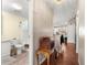 Hallway view showcasing access to the bathroom, kitchen, and other living spaces at 1854 W Schwartz Blvd, Lady Lake, FL 32159