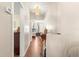 A bright hallway with wood floors leads to the bedrooms at 1854 W Schwartz Blvd, Lady Lake, FL 32159