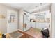 A cozy kitchen is displayed with white cabinets, a window, and wood-look flooring for a traditional style at 1854 W Schwartz Blvd, Lady Lake, FL 32159