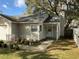 Home exterior showing the front entrance with small porch area and a small garden at 2001 Donnelly Pl, Mount Dora, FL 32757