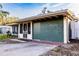 Cozy home with a screened front porch, colorful exterior, and a driveway on the side of the home at 2026 Sunset Ln, Clermont, FL 34711