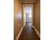 Hallway with wood floors leading to a bedroom with a window at 2026 Sunset Ln, Clermont, FL 34711