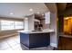 Kitchen island has quartz countertops and a stainless faucet and sink at 2026 Sunset Ln, Clermont, FL 34711