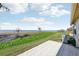 Spacious backyard with a waterfront view, grassy lawn, and a stone patio, perfect for outdoor entertaining at 2229 Cypress Ct # C-4, Tavares, FL 32778
