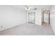 Spacious bedroom featuring carpet, walk-in closet with mirrored doors, and neutral paint at 2229 Cypress Ct # C-4, Tavares, FL 32778