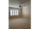 Bedroom with neutral carpet, paint, plantation shutters, and ceiling fan at 2229 Cypress Ct # C-4, Tavares, FL 32778