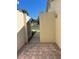 A charming courtyard features brick pavers and a metal gate, offering a private entrance to the home at 2229 Cypress Ct # C-4, Tavares, FL 32778
