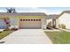 Attached garage with a concrete driveway and manicured lawn provides convenience and curb appeal at 2229 Cypress Ct # C-4, Tavares, FL 32778
