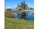 Picturesque waterfront view showcasing a tranquil lake with lush vegetation, and a charming dock perfect for serene escapes at 2229 Cypress Ct # C-4, Tavares, FL 32778