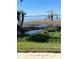 Scenic view of a serene lake with lush vegetation and clear blue skies providing a tranquil waterfront experience at 2229 Cypress Ct # C-4, Tavares, FL 32778