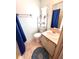 Bathroom with a vanity, toilet, and blue accents at 224 Westwood Dr, Leesburg, FL 34748