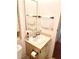 This bathroom features a single sink vanity with tile backsplash, a large mirror, and brushed bronze fixtures at 224 Westwood Dr, Leesburg, FL 34748