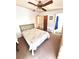 Bedroom featuring a comfortable bed, ceiling fan, and convenient access to the bathroom and closet at 224 Westwood Dr, Leesburg, FL 34748