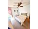 Bright bedroom with a ceiling fan and a comfortable bed, well-lit by a window at 224 Westwood Dr, Leesburg, FL 34748