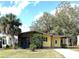 Charming single-story home with a covered carport, screened porch, and lush green lawn at 224 Westwood Dr, Leesburg, FL 34748