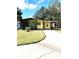 Inviting single-story home featuring a covered carport and lush green lawn at 224 Westwood Dr, Leesburg, FL 34748