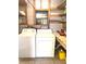 Interior laundry room with open shelving for storage and a large window for natural light at 224 Westwood Dr, Leesburg, FL 34748