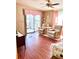 Comfortable living room with laminate flooring, two reclining chairs and access to outdoor patio at 224 Westwood Dr, Leesburg, FL 34748