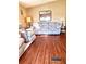 Spacious living room featuring laminate flooring, a plush sofa, and plenty of natural light at 224 Westwood Dr, Leesburg, FL 34748