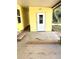 Back patio with side entrance to the home and space to relax with mature landscaping at 224 Westwood Dr, Leesburg, FL 34748