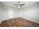 This bedroom has wood-look floors, neutral walls and ceiling and multiple doors at 2289 Se 110Th Ave, Webster, FL 33597