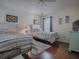 Shared bedroom features two beds, hardwood floors, and a cozy atmosphere at 2367 Camden Ter, The Villages, FL 32162