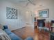 Bright bedroom featuring hardwood floors, a comfortable sofa, and ample natural light at 2367 Camden Ter, The Villages, FL 32162