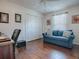 Well-lit bedroom with hardwood floors, a large closet, and comfortable seating at 2367 Camden Ter, The Villages, FL 32162
