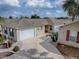 Charming single-story home featuring a two-car garage and a well-manicured lawn, creating a welcoming curb appeal at 2367 Camden Ter, The Villages, FL 32162