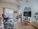 Bright living room features hardwood floors, comfortable seating, and sliding door access to the backyard at 2367 Camden Ter, The Villages, FL 32162