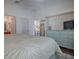 Well-lit main bedroom featuring a large bed, dresser, and a view into the ensuite bathroom at 2367 Camden Ter, The Villages, FL 32162