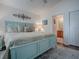 Comfortable main bedroom featuring a large bed, decor and an ensuite bathroom at 2367 Camden Ter, The Villages, FL 32162