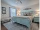 Inviting main bedroom with a patterned rug, a large bed and decor at 2367 Camden Ter, The Villages, FL 32162