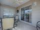 The screened patio offers views of the fenced backyard through a glass sliding door and a ceiling fan at 2367 Camden Ter, The Villages, FL 32162