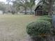 The backyard has a barn near a treeline and an outbuilding in the distance at 2416 Spring Lake Rd, Fruitland Park, FL 34731