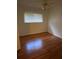 Standard bedroom featuring hard wood floors, neutral colored walls, and a ceiling fan at 2416 Spring Lake Rd, Fruitland Park, FL 34731