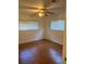 Standard bedroom featuring hard wood floors, neutral colored walls, and a ceiling fan at 2416 Spring Lake Rd, Fruitland Park, FL 34731