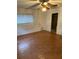 Bedroom with wood floors, ceiling fan and closet at 2416 Spring Lake Rd, Fruitland Park, FL 34731