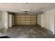 Wide open garage with a door and a storage area features a bright interior at 2416 Spring Lake Rd, Fruitland Park, FL 34731