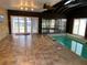 Indoor pool room boasts tile floors, lots of light, access to screened in porch, and a full size pool at 2416 Spring Lake Rd, Fruitland Park, FL 34731