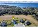 Aerial view of a home near a lake and bordering preserved land with other homes nearby at 2510 Glacier Express Ln, Tavares, FL 32778