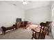 Bedroom featuring a bed, a rocking chair, a TV, and a small window with natural light at 2510 Glacier Express Ln, Tavares, FL 32778