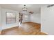 Bright living room featuring wood-look tile flooring, stylish light fixture, and sliding glass door at 2701 Ne 10Th St # 307, Ocala, FL 34470