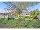 Large backyard featuring lush greenery, mature trees, privacy fence, and play structure for Gathering fun at 2727 Retriever Dr, Clermont, FL 34711
