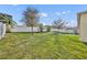 Large, well-maintained backyard with lush green grass and a privacy fence, perfect for outdoor activities at 2727 Retriever Dr, Clermont, FL 34711