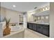 Bright bathroom features a jacuzzi tub, dual sink vanity, and an open doorway to the main bedroom at 2727 Retriever Dr, Clermont, FL 34711