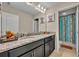 Bathroom featuring granite countertops, dual sinks, large mirror, and tub/shower combo at 2727 Retriever Dr, Clermont, FL 34711
