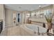 Well-lit primary bathroom with a large soaking tub, shower with glass partition, and tiled floor at 2727 Retriever Dr, Clermont, FL 34711